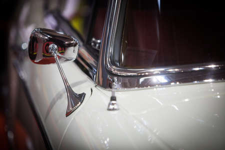 Close up shot of a vintage car side mirror.