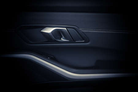 Close up shot of a car's door opener from the inside.