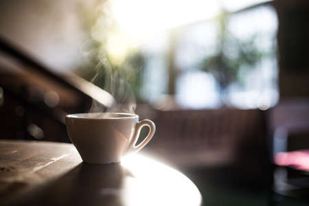 Image of a steamy coffee cup in the sunlight, with shallow depth of field.の写真素材