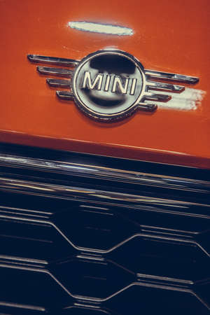 Bucharest, Romania - October 23, 2019: Illustrative editorial close up shot of the Mini logo on a car. Mini is a small car produced by the English-based British Motor Corporation.のeditorial素材