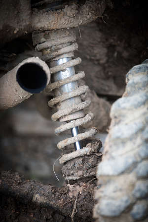 Close up shot of a muddy shock absorber of an off road car.の写真素材