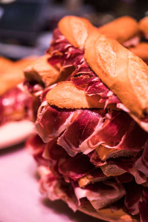 Close up shot of a pile of jamon sandwiches, a Spanish traditional dish.
