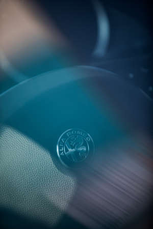 Bucharest, Romania - October 23, 2019: Illustrative editorial close up shot of the Alfa Romeo logo on a car's steering wheel. Alfa Romeo is an Italian luxury car manufacturer.のeditorial素材