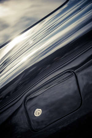 Close up shot of a fuel cap on a vintage car.
