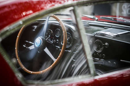 Color close up of the wooden steering wheel of an old classic car.の写真素材