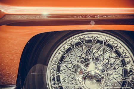 Close up shot of a vintage classic car spoke wheel.