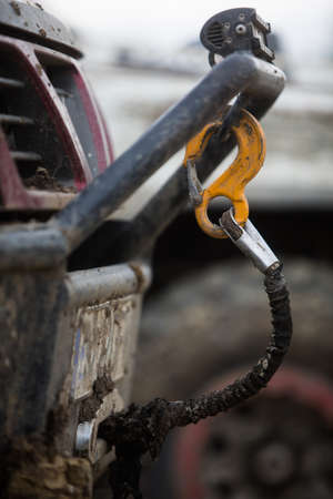 Close up shot of the hook of a winch on a dirty off road vehicle.の写真素材