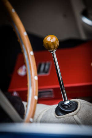 Close up vertical shot of the gear shifter of a vintage car.