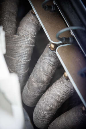 Close up shot of some exhaust pipes covered with thermal tape.の写真素材
