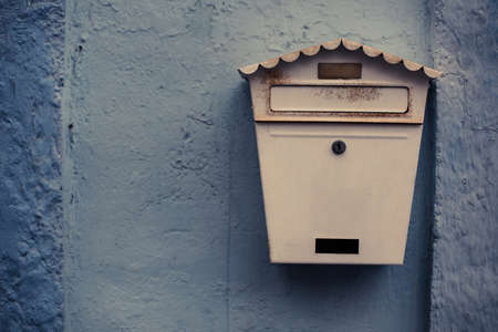 An old classic postal box on a wall.の写真素材
