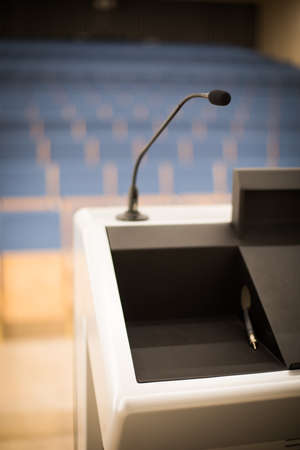 Close up shot of a microphone in an empty conference room.の写真素材