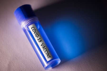 Conceptual image of a recipient containing a vaccine for coronavirus COVID-19, in a lab.