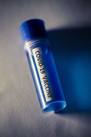 Conceptual image of a recipient containing a vaccine for coronavirus COVID-19, in a lab.