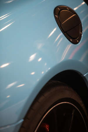 Close up shot of a car's fuel reservoir lid.