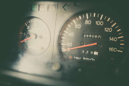 Color close up shot of a blue speedometer on a vintage car's dashboard.の写真素材