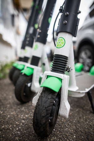 Bucarest, Romania - May 26. 20202: Image of some Lime-s e-scooters parked on sidewalk in Bucharest, Romania.のeditorial素材