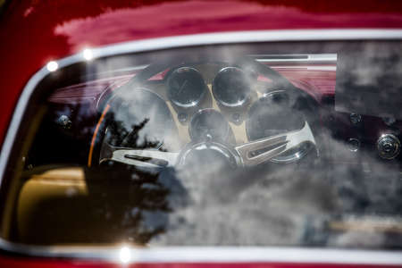 Color close up of the wooden steering wheel of an old classic car.の写真素材