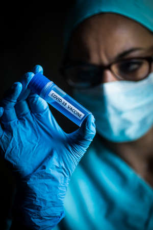 Conceptual image of a nurse holding a recipient with the coronavirus COVID-19 vaccine.