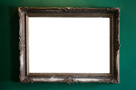 Image o a classic vintage painting frame, wit copy space, on a green wall.の写真素材
