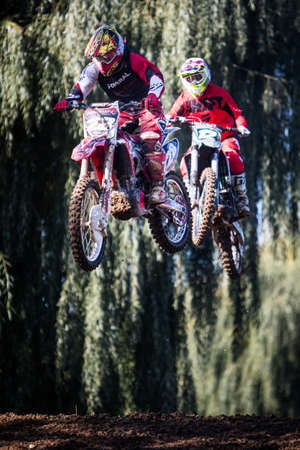 Ciolpani, Romania - October 11, 2002: A rider jumps with his motorcycle, while taking part in a motocross race in Ciolpani, Romania.のeditorial素材