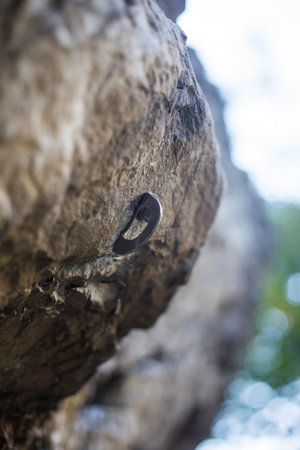 Close up shot of a metal rig drilled into stone, safety device used in rock climbing.の写真素材