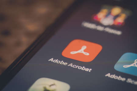 Bucharest, Romania - December 13, 2020: Illustrative editorial close up image of the Adobe Acrobat mobile app on a smartphone screen.のeditorial素材