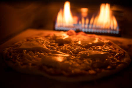 Close up shot of a pizza baking in an oven.の写真素材
