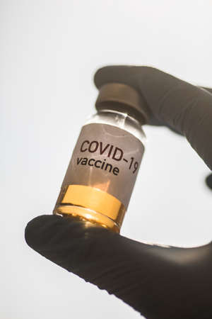 Image of a female doctor holding a COVID-19 vaccine, illustration for the new coronavirus pandemic.の写真素材