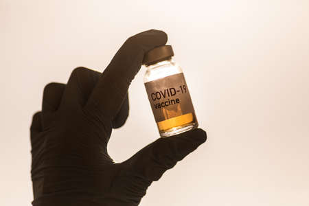 Image of a female doctor holding a COVID-19 vaccine, illustration for the new coronavirus pandemic.