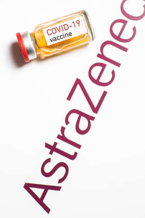 Bucharest, ROMANIA - March 15, 2021: Illustrative editorial concept image with a dose of the new Coronavirus COVID-19 vaccine, with the AstraZeneca logo in the background.のeditorial素材