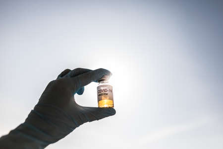 Image of a female doctor holding a COVID-19 vaccine, illustration for the new coronavirus pandemic.