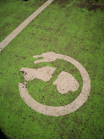 Painted sign for electric vehicle parking on the ground.のeditorial素材