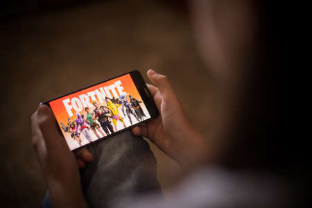 Bucharest, ROMANIA - May 10, 2021: Illustrative editorial concept image of a child playing Fortnite...