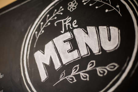 Close up shot of the word Menu written on a chalkboard.の写真素材