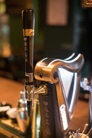 Bucharest, Romania - January 27, 2020: Illustrative editorial image of a Guinness beer tap in a pub...
