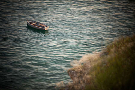 High angle image of a empty wooden boat floating on water.の写真素材
