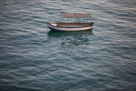 High angle image of a empty wooden boat floating on water.