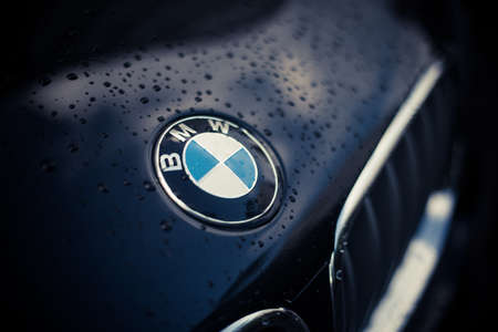 Bucharest, ROMANIA - May 16, 2021: Illustrative editorial close up shot with the wet hood of a BMW car, with the manufacturer logo on it.のeditorial素材