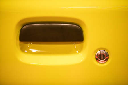Close up shot of a modern door handle of a yellow car.の写真素材