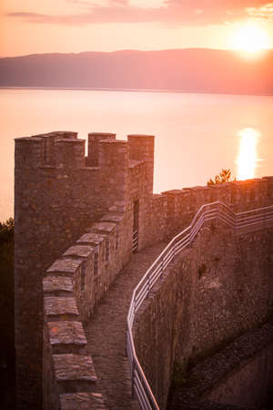 Walls and towers of castle Samuil at sunset, on background the blue waters of Ohrid lake, North Macedonia.のeditorial素材