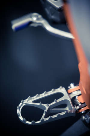 Motorcycle foot peg. Detail of an off road motorcycle foot rest and control.の写真素材