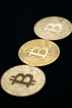 Close up shot of three aligned golden and silver bitcoin digital cryptocurrency.の写真素材