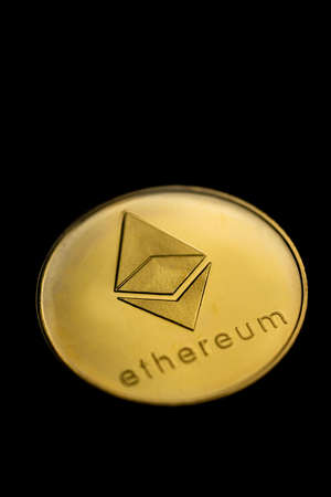 Close up shot of a golden Ethereum digital cryptocurrency.の写真素材