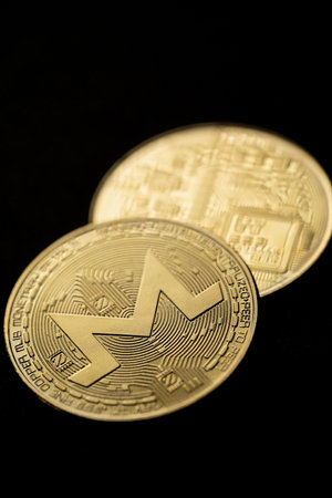 Close up shot of a golden Monero XMR digital cryptocurrency.の写真素材