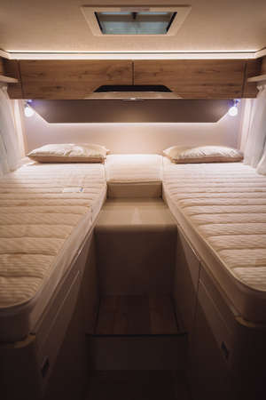 Image of the bed inside a new luxury camper van motorhome.