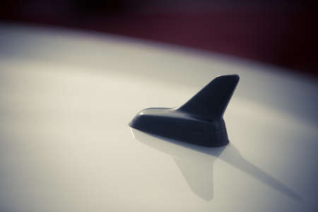 Close-up GPS antenna shark fin shape on a roof of car for radio navigation system.の写真素材