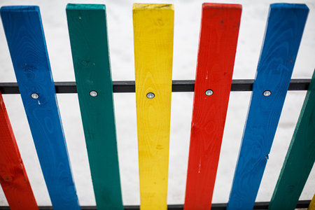 Colorful wooden fence on a white background.