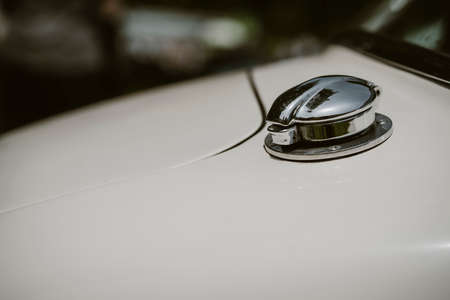 Fuel tank cap with key slot on white vintage car or bus.の写真素材