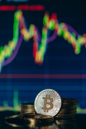 Stack or heap of gold Bitcoins cryptocurrency with candle stick graph chart and digital background.の写真素材