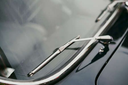 Close up shot of a vintage screen wiper on a car's windshield.の写真素材